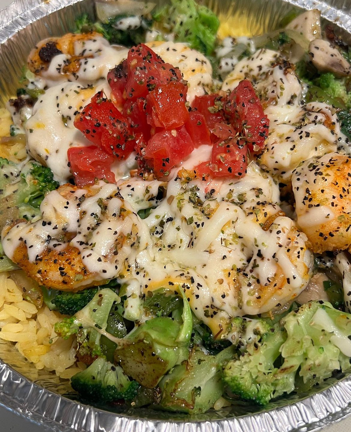 Grilled shrimp bowl with broccoli, rice and diced tomato
