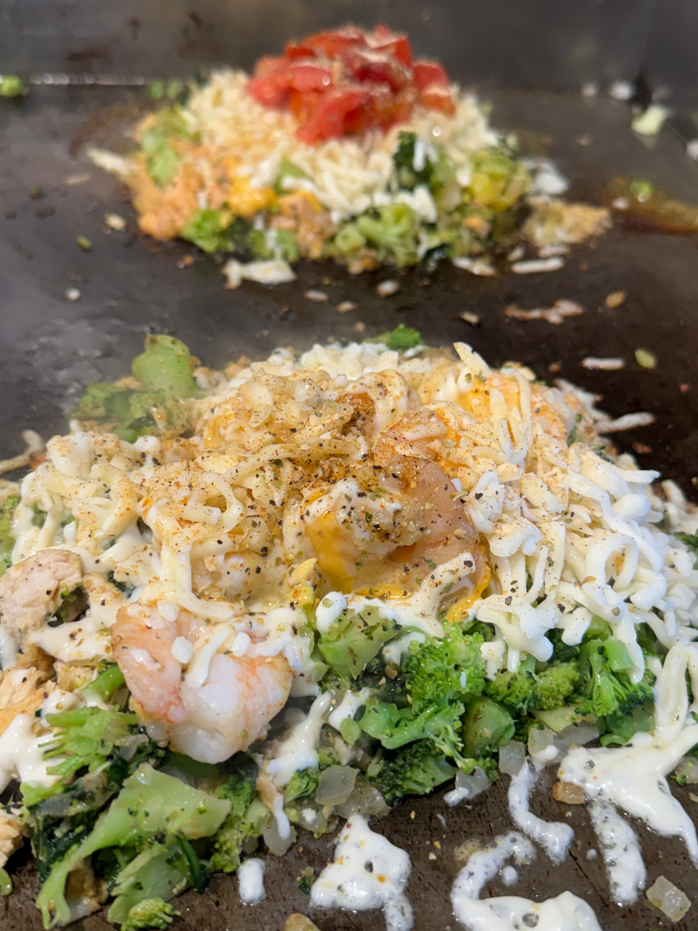 Shrimp and broccoli cooking on the flat-top grill