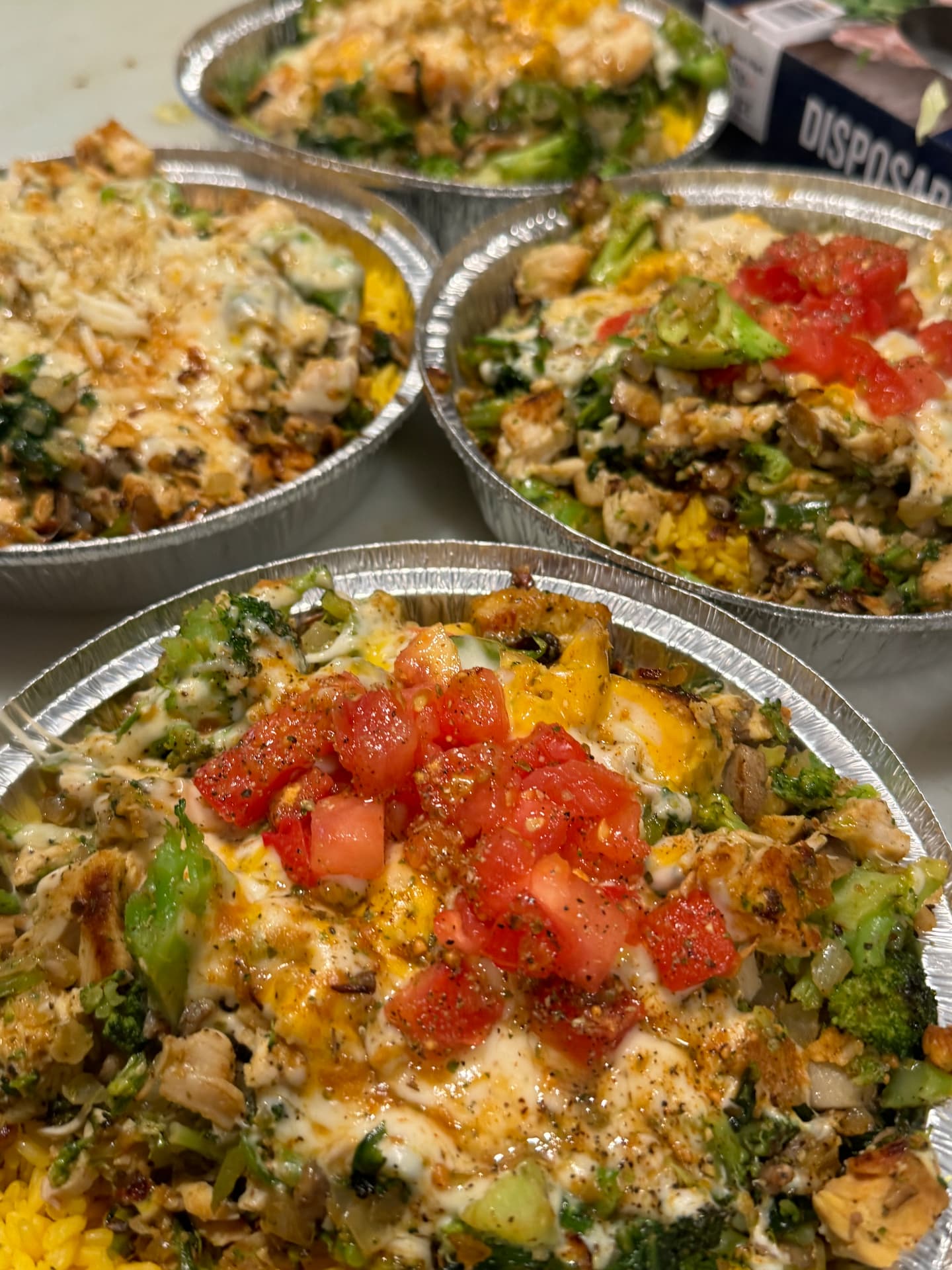 Row of grilled chicken and shrimp bowls ready for pickup